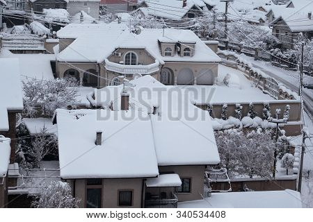 Beautiful Winter View Of Houses And Buildings With Roofs Covered With Heavy Snow. In Snowy Season, R