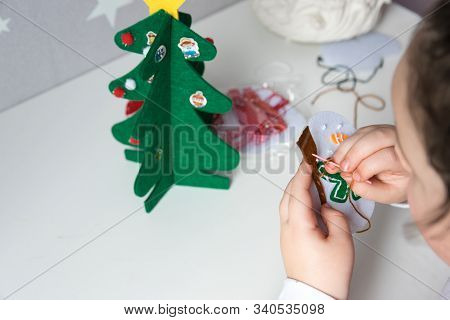 The Hand Of The Child Make Snowman And Christmas Tree With Needle, Thread For Christmas Greeting Car