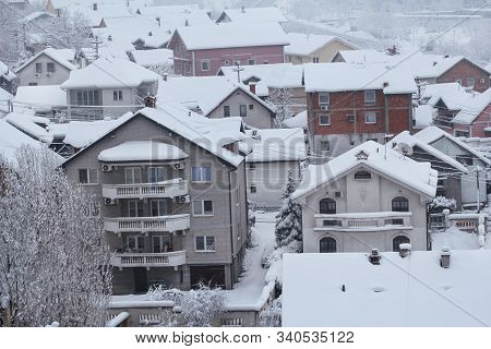 Beautiful Winter View Of Houses And Buildings With Roofs Covered With Heavy Snow. In Snowy Season, R