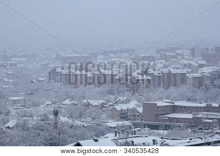 Beautiful Winter View Of Houses And Buildings With Roofs Covered With Heavy Snow. In Snowy Season, R