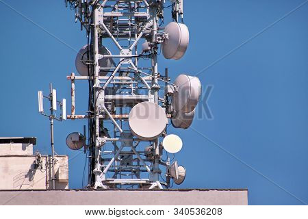 Telecommunication Base Stations Network Repeaters On The Roof Of Building. The Cellular Communicatio