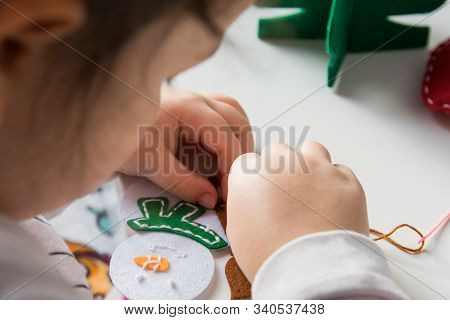 The Hand Of The Child Make Snowman For Christmas Greeting Card. Hobby Concept. Handmade.
