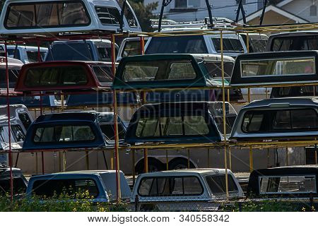 Stacks Of Colorful Campershells For Trucks In A Row For Sale