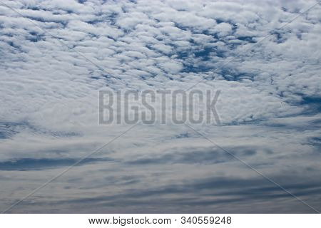 White Whispy Clouds Covering A Blue Sky