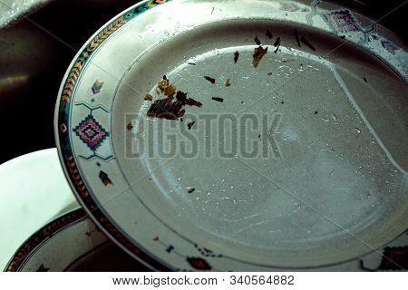 Unwashed Dishes Inside A Kitchen Sink