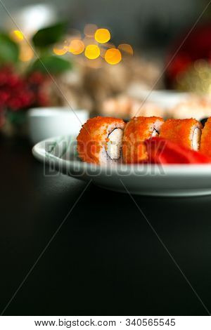 California Rolls And Sushi Poppies On Christmas Table With Ginger And Sticks/ Space For Text