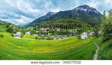 Lavin, Switzerland, May 13, 2018. Beautiful view of Lavin municipality situated on the Inn river bank between mountains.