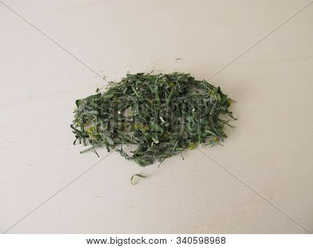 Dried Hedge Mustard On A Wooden Board