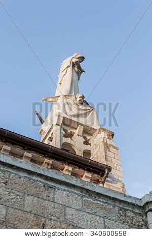 Jerusalem, Israel, December 07, 2019 : Statue Of The Mother Of God With A Baby In Her Arms On The Ro