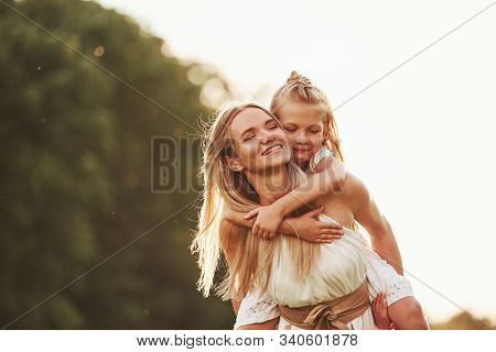 I Hold You, Dont Worry. Mother And Daughter Enjoying Weekend Together By Walking Outdoors In The Fie