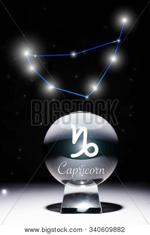Crystal Ball With Capricorn Zodiac Sign Isolated On Black With Constellation