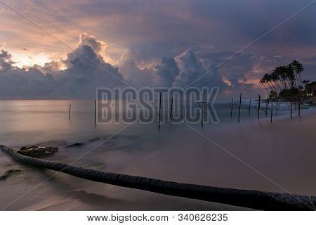 Koggala, Sri Lanka : 2019 Nov 18 :silhouettes Of The Traditional Sri Lankan Stilt Fishermen On A Sto