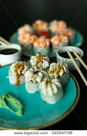 Sushi Rolls In Blue Plate, Chopsticks, Soy Sauce, Ginger And Wasabi