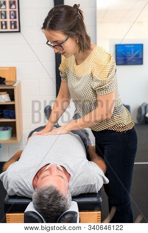 Man Having Chiropractic Back Adjustment. Physioterapy, Osteopathy, Alternative Medicine Pain Relief 