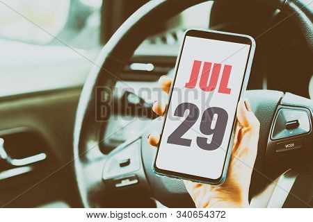 July 29th. Day 29 Of Month, Calendar Date. Month And Day Placed On A Smartphone Screen In Womans Han
