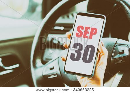 September 30th. Day 30 Of Month, Calendar Date. Month And Day Placed On A Smartphone Screen In Woman