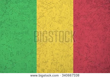Mali Flag Depicted In Bright Paint Colors On Old Relief Plastering Wall. Textured Banner On Rough Ba