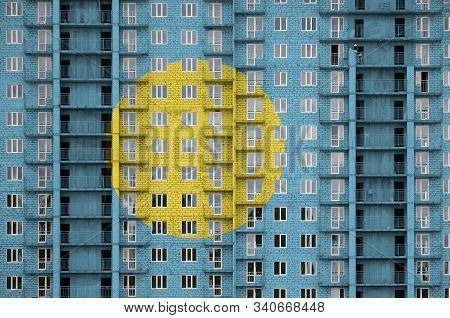 Palau Flag Depicted In Paint Colors On Multi-storey Residental Building Under Construction. Textured