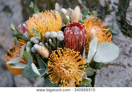 Luxury Wedding Bouquet With Pink And Orange Protea Flowers On Stone Background, Copy Space. Greeting