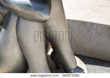 Porec, Croatia, August 19, 2019: A Cut - Off Image Of A Bronze Sculpture Of A Sitting Buxom Woman In