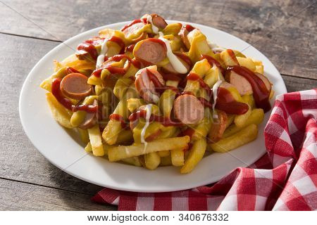 Typical Latin America Salchipapa. Sausages With Fries, Ketchup.