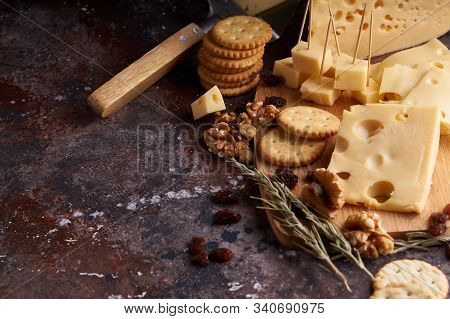 Pieces Of Cheese, Nuts, Raisins, Snacks For Wine On A Wooden Background. Appetitive