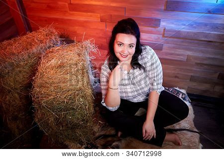 Portrait Of Fat Plump Fun Charming Cute Woman With Black Hair In The Room With Hay And Straw