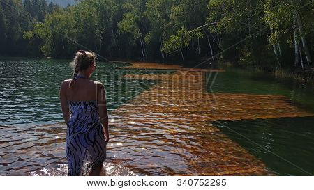 Woman Walk On Water On Pier In Sunglasses And A Boho Silk Shawl. Girl Rest On Flood Wood Underwater 
