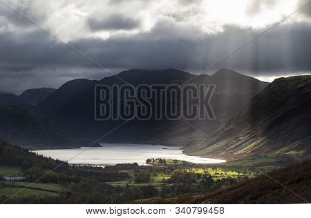 Epic Sun Beams Light Up Crummock Water In Dramatic Autumn Fall Landscape Image With Mellbreak And Gr