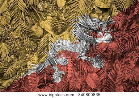 Bhutan Flag Depicted On Many Leafs Of Monstera Palm Trees. Trendy Fashionable Backdrop