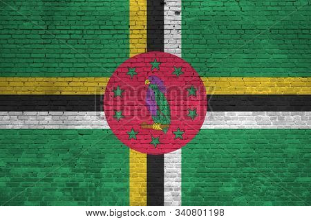 Dominica Flag Depicted In Paint Colors On Old Brick Wall. Textured Banner On Big Brick Wall Masonry 