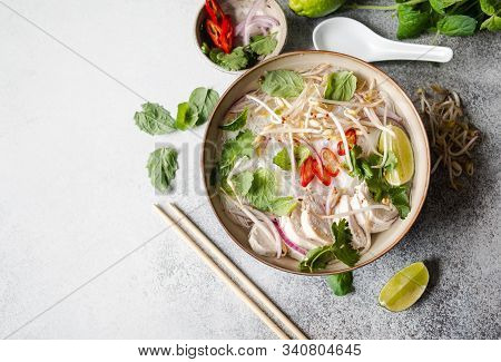 Traditional Vietnamese Soup- Pho Ga In Bowl With Chicken And Rice Noodles, Mint And Cilantro, Red On