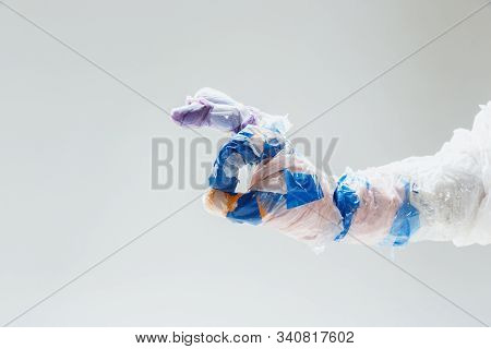 Big Plastic Hand Made Of Garbage Isolated On White Studio Background. The Result Of Polymers Overusi