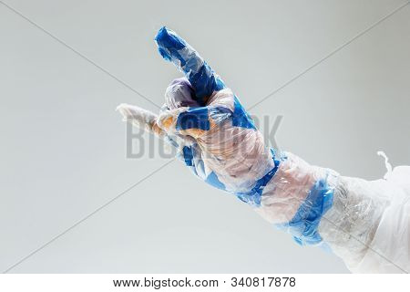 Big Plastic Hand Made Of Garbage Isolated On White Studio Background. The Result Of Polymers Overusi