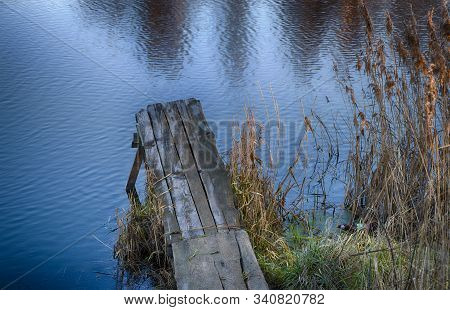 River Pier In Sedge And Calamus. Relaxation And Relaxation On The Beach. Belarus. Salihorsk.