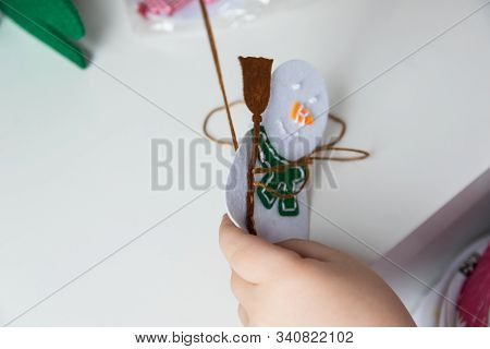 The Hand Of The Child Make Snowman For Christmas Greeting Card. Xmas Toys Decoration For Greeting Ca
