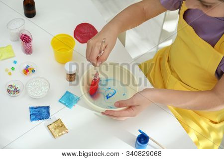 Little Girl Mixing Ingredients With Silicone Spatula At Table, Closeup. Diy Slime Toy