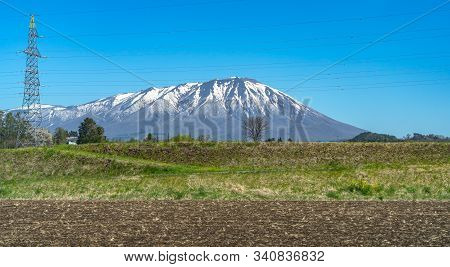 Snow Capped Mount Iwate With Clear Blue Sky Natural Background, Beauty Townscape Of Takizawa And Shi
