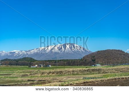 Snow Capped Mount Iwate With Clear Blue Sky Natural Background, Beauty Townscape Of Takizawa And Shi