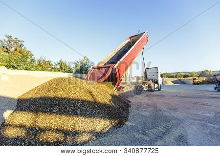 Dump Truck Unloads Crushed Stone From The Body At The Concrete Plant. The Dump Truck Lifts The Body 