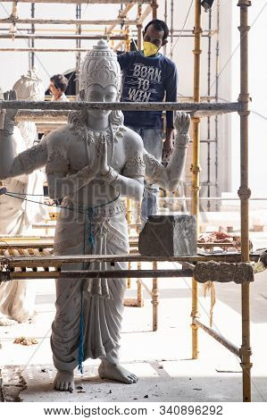 Tovp, Mayapur. West Bengal, India. - Dec 16, 2019. Artisan Working On Sculpture On The Building Of T