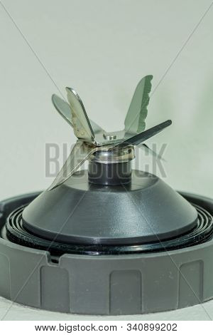 Side View Of Blender Cutting Blades On Textured White Background.