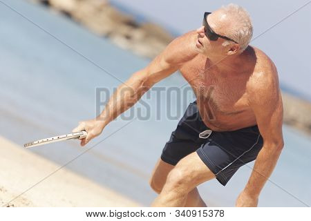 Adult Male Playing Matkot On The Beach