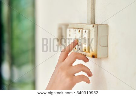 Female Hand, To Turn Off The Light, Switch, Side View.
