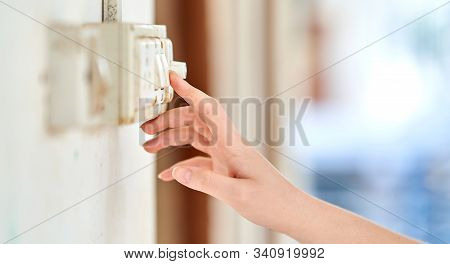 Female Hand, To Turn Off The Light, Switch, Side View.