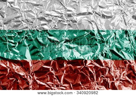 Bulgaria Flag Depicted In Paint Colors On Shiny Crumpled Aluminium Foil Closeup. Textured Banner On 