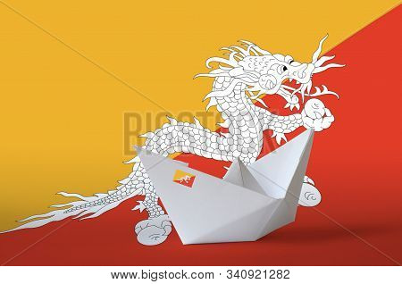 Bhutan Flag Depicted On Paper Origami Ship Closeup. Handmade Arts Concept