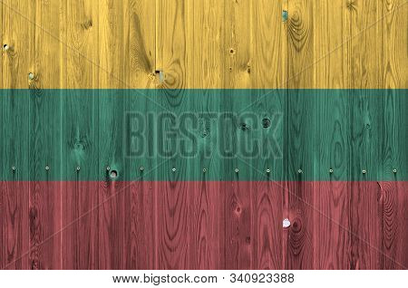 Lithuania Flag Depicted In Bright Paint Colors On Old Wooden Wall. Textured Banner On Rough Backgrou
