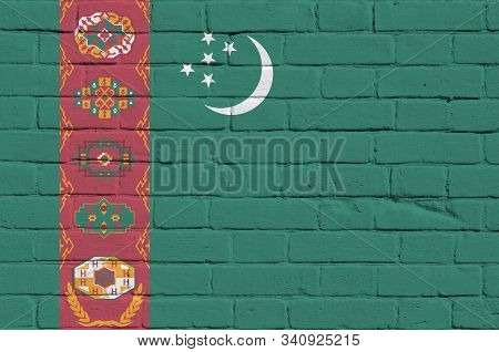 Turkmenistan Flag Depicted In Paint Colors On Old Brick Wall. Textured Banner On Big Brick Wall Maso