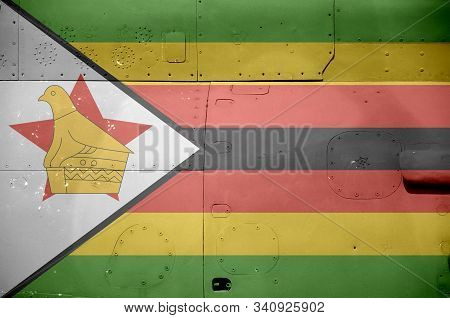 Zimbabwe Flag Depicted On Side Part Of Military Armored Helicopter Closeup. Army Forces Aircraft Con